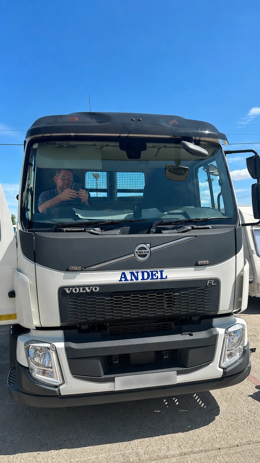 Engineer working in the cab of a Volvo FL rigid